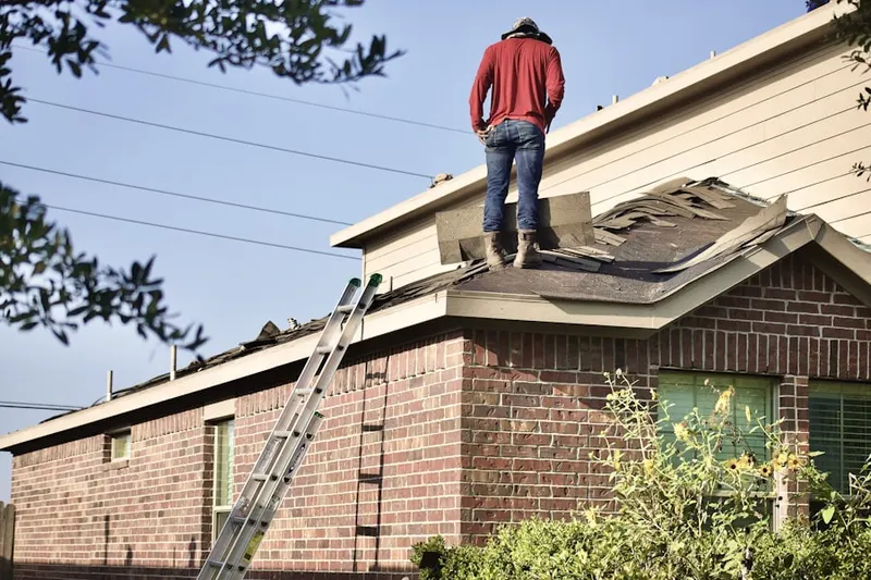 Professional roofer working on a residential roof in Bradley